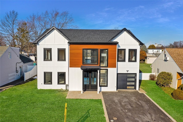 exterior space with a garage and a lawn