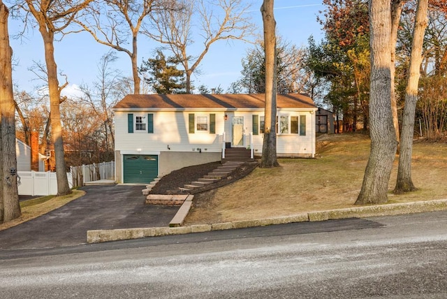 view of front of property with a front yard and a garage