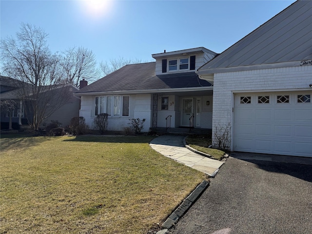 view of front of house with a front yard and a garage