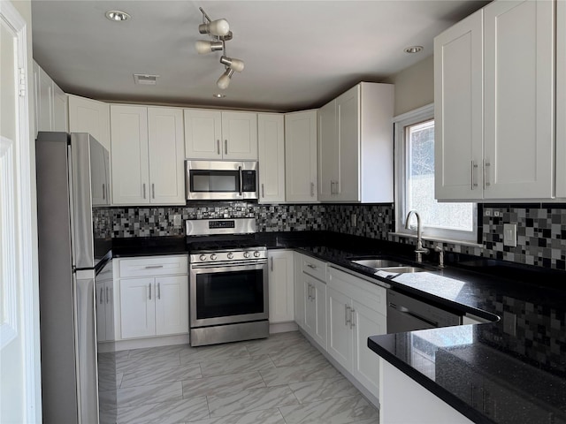 kitchen with sink, white cabinets, and appliances with stainless steel finishes