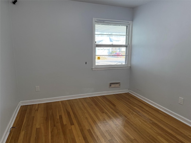 spare room featuring wood-type flooring