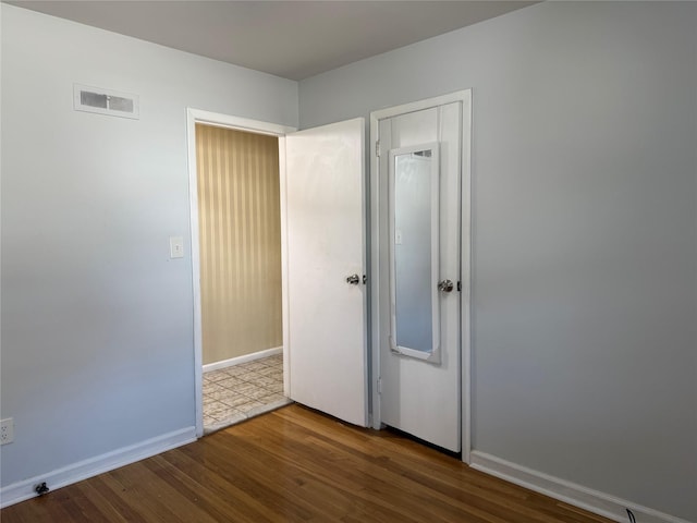 unfurnished bedroom with hardwood / wood-style floors