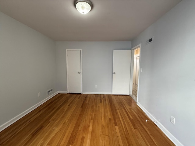 unfurnished bedroom featuring hardwood / wood-style flooring