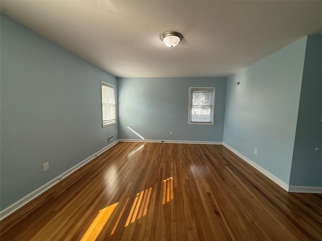 unfurnished room with dark hardwood / wood-style floors