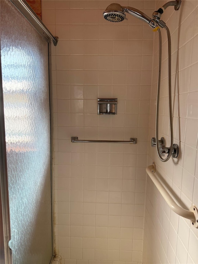 bathroom with a shower with shower door