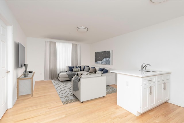 living room with sink and light wood-type flooring