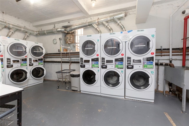 laundry area with stacked washer / dryer and washer and clothes dryer