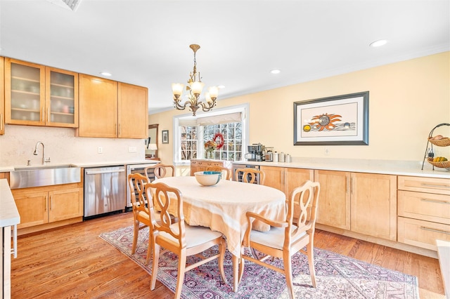 dining area with recessed lighting, light wood-type flooring, an inviting chandelier, and crown molding