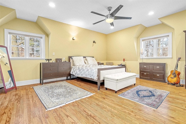 bedroom featuring a ceiling fan, wood finished floors, recessed lighting, baseboards, and vaulted ceiling