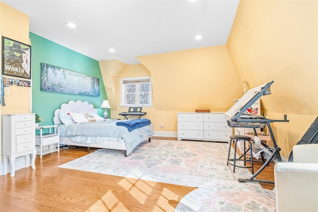 bedroom with recessed lighting and wood finished floors