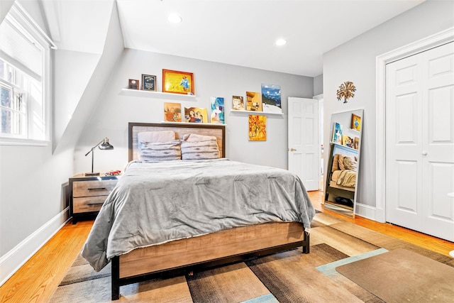 bedroom with recessed lighting, wood finished floors, and baseboards