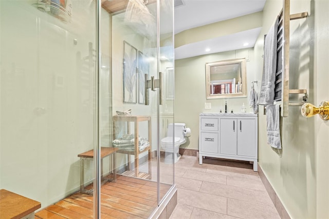 full bathroom featuring vanity, tile patterned floors, toilet, and a stall shower