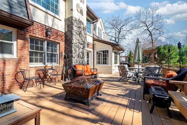 wooden deck featuring a fire pit