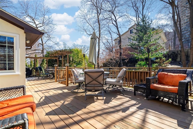 deck with outdoor dining space and a pergola