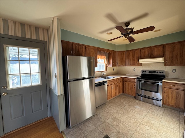 kitchen featuring ceiling fan, sink, and stainless steel appliances