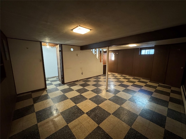 basement featuring wood walls