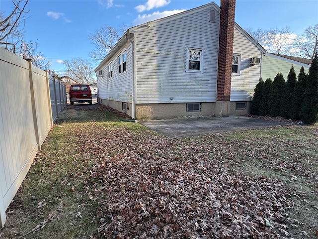 view of side of home with a patio area