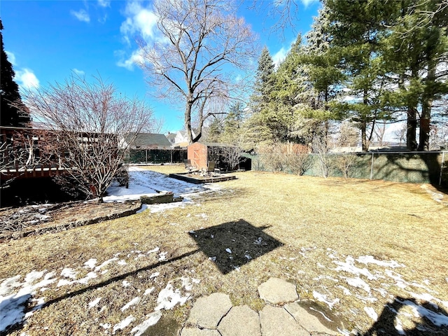 snowy yard with a storage shed