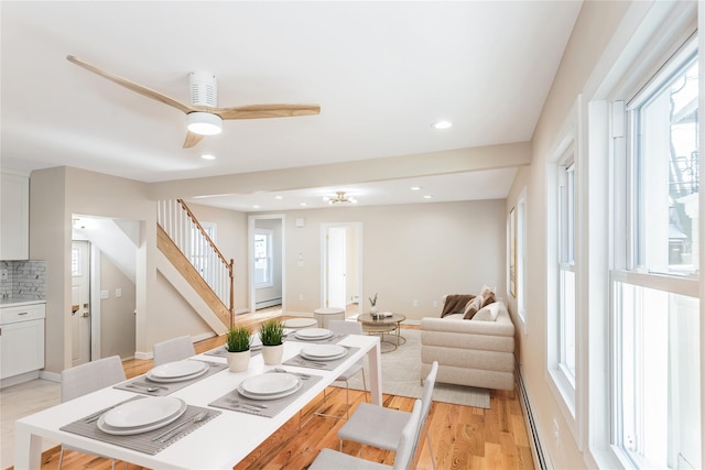 dining room with plenty of natural light, ceiling fan, and light wood-type flooring