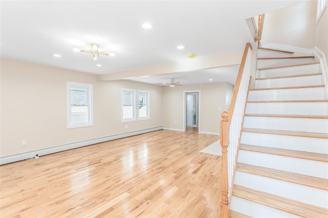 interior space featuring baseboard heating and hardwood / wood-style floors