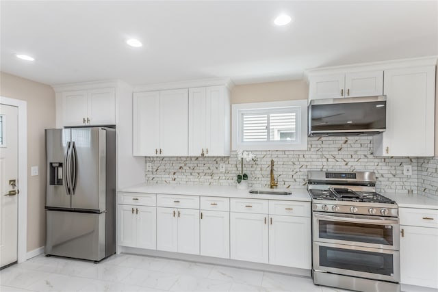 kitchen featuring white cabinetry, sink, tasteful backsplash, and appliances with stainless steel finishes