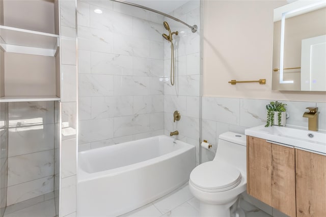 full bathroom featuring tiled shower / bath, vanity, toilet, and tile walls