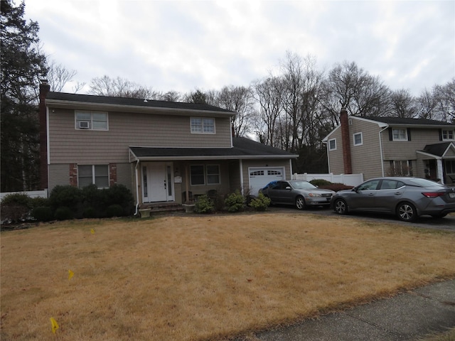 front facade featuring a front lawn and a garage