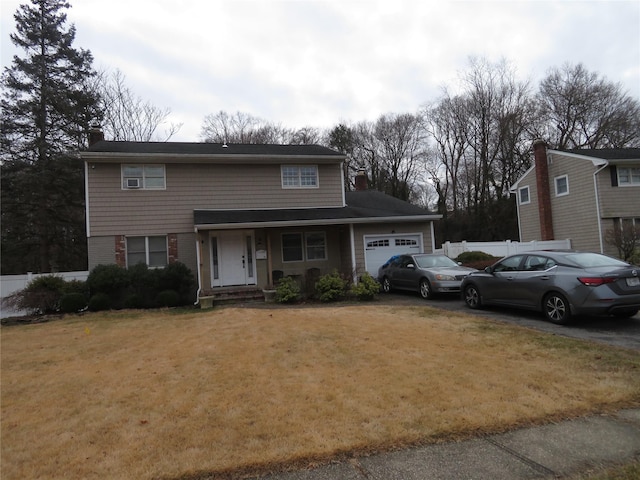 front facade featuring a front yard and a garage