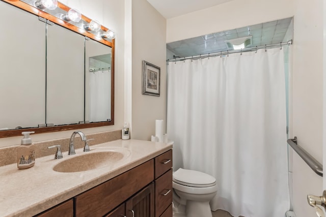 bathroom featuring toilet and vanity