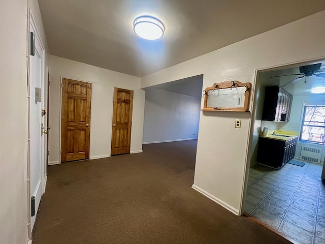 corridor featuring sink and radiator heating unit