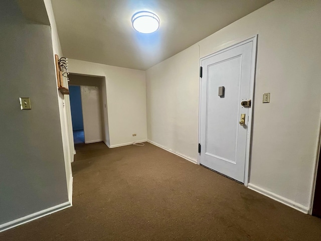 empty room featuring dark colored carpet