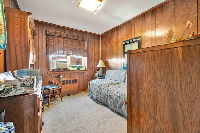 carpeted bedroom with radiator, cooling unit, and wooden walls