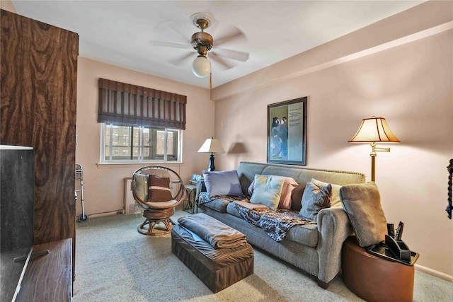 living room with ceiling fan and carpet