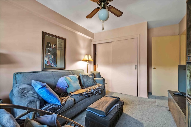 living room featuring ceiling fan and carpet floors