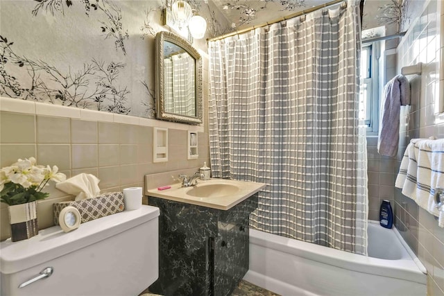 full bathroom with toilet, vanity, tile walls, and shower / bath combination with curtain