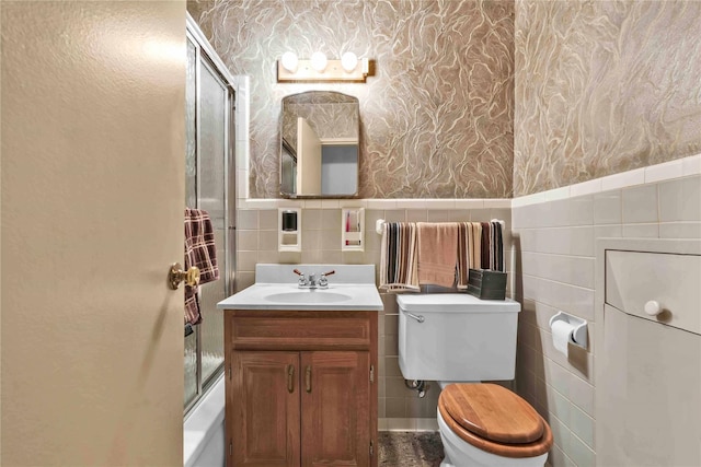 bathroom featuring tile walls, toilet, and vanity