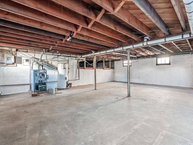 basement with water heater and electric panel