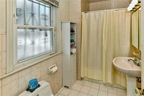 bathroom featuring tile patterned floors, toilet, and a shower with curtain