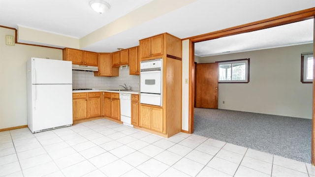 kitchen featuring white appliances, light carpet, sink, backsplash, and crown molding