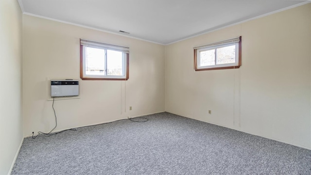 carpeted empty room featuring a wealth of natural light, ornamental molding, and a wall mounted AC