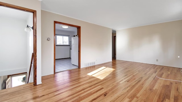 empty room with light hardwood / wood-style floors