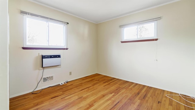 unfurnished room with light hardwood / wood-style floors and crown molding