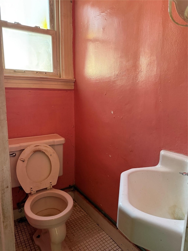 bathroom featuring toilet, tile patterned flooring, and sink