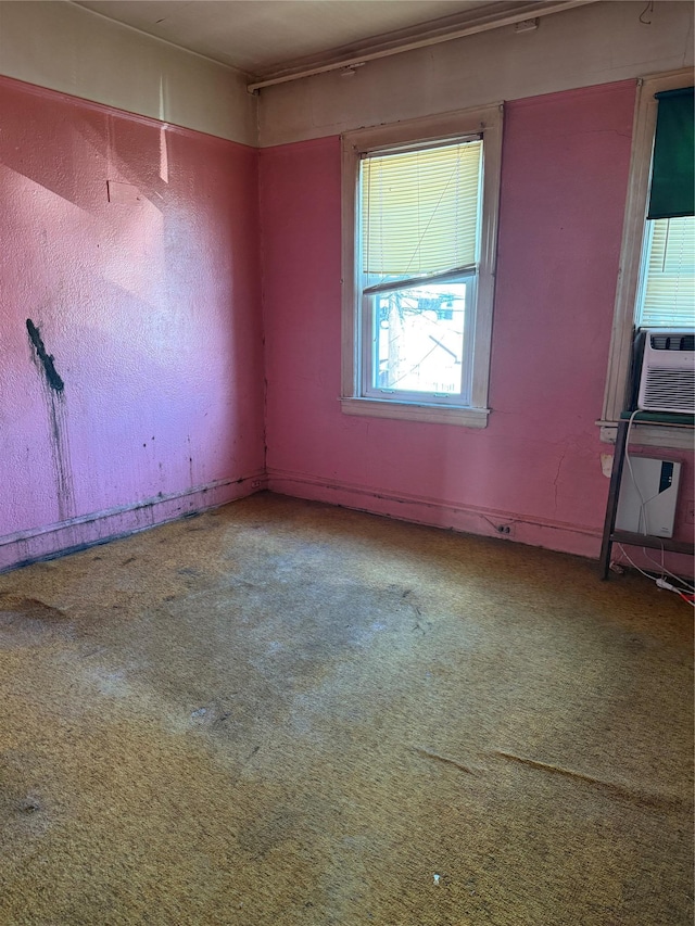 spare room with cooling unit and carpet flooring