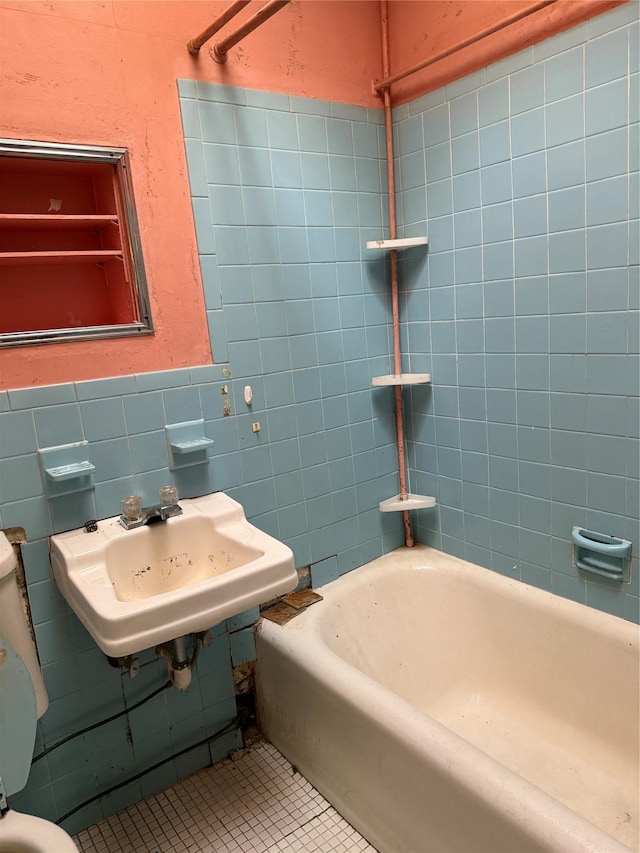 bathroom featuring toilet, tile patterned flooring, and sink