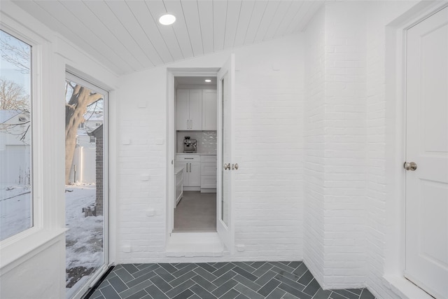 hallway featuring vaulted ceiling