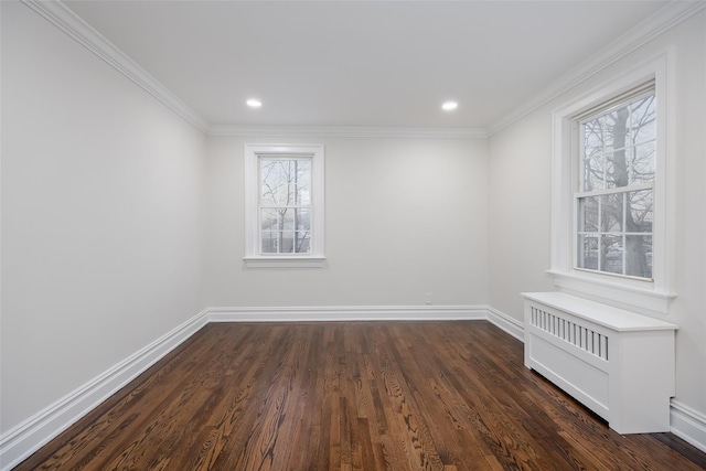 spare room featuring crown molding and dark wood-type flooring