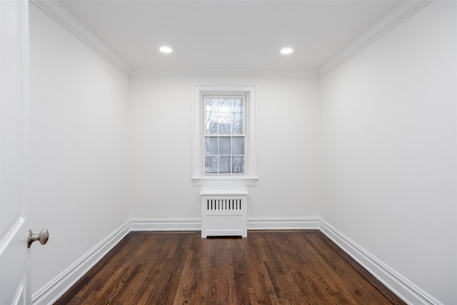 spare room featuring dark wood-type flooring and ornamental molding