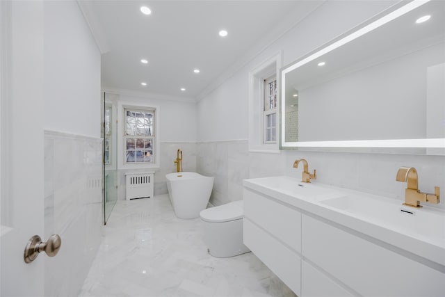 bathroom featuring radiator, crown molding, a bathtub, vanity, and toilet