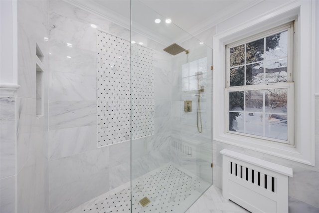 bathroom featuring ornamental molding, radiator heating unit, and a tile shower